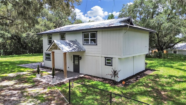 rear view of property with a lawn