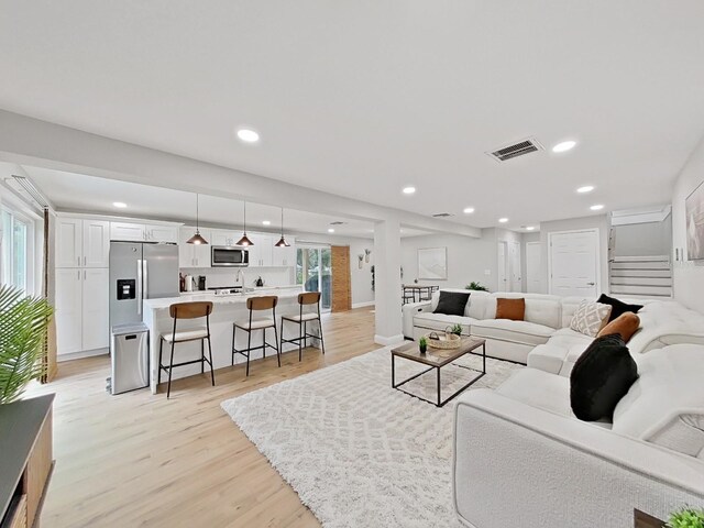 living room with plenty of natural light and light wood-type flooring