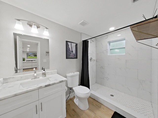 bathroom featuring curtained shower, vanity, wood-type flooring, and toilet