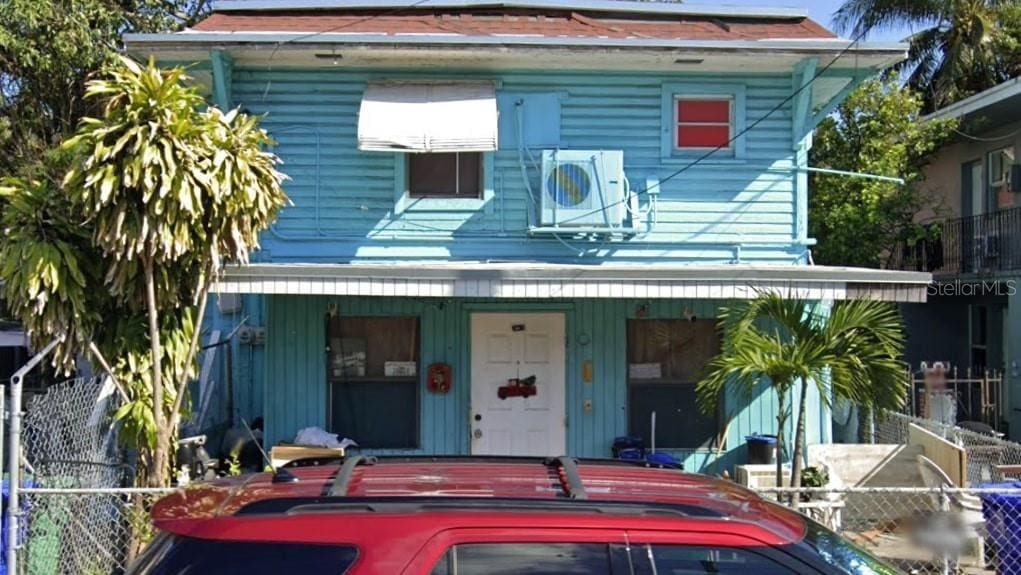 211 SW 9th Ave, Miami, FL 33130 - view of front of home featuring covered porch, fence, and a cooling unit