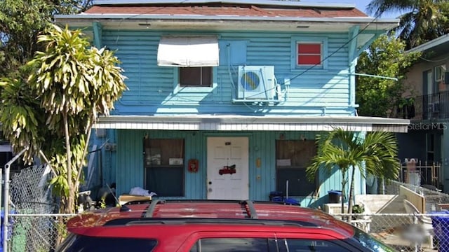 211 SW 9th Ave, Miami, FL 33130 - view of front of home featuring covered porch, fence, and a cooling unit