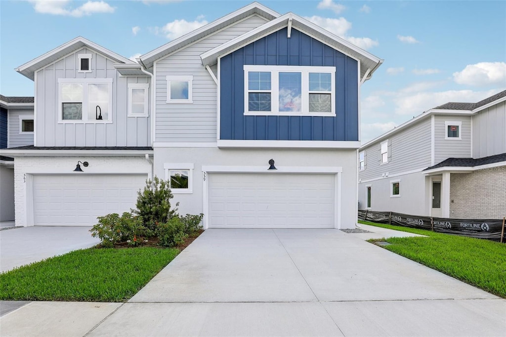 view of front of house featuring board and batten siding, driveway, and an attached garage