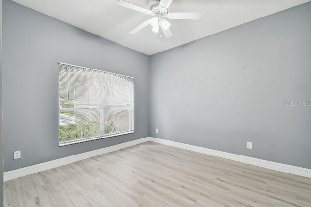 spare room featuring ceiling fan and light hardwood / wood-style floors