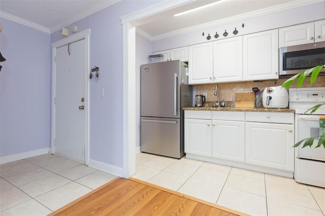 kitchen featuring white cabinetry, crown molding, light hardwood / wood-style floors, appliances with stainless steel finishes, and backsplash