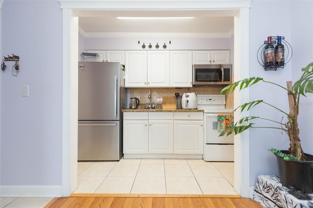 kitchen with appliances with stainless steel finishes, light hardwood / wood-style flooring, crown molding, and white cabinets