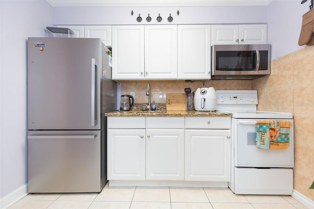 kitchen featuring white cabinetry, stainless steel appliances, crown molding, and light tile patterned floors