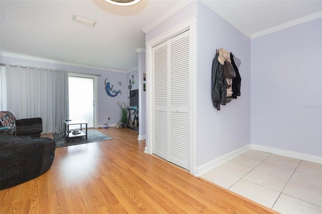 living room featuring crown molding and light wood-type flooring