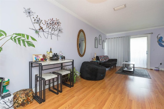 living room featuring light wood-type flooring and ornamental molding