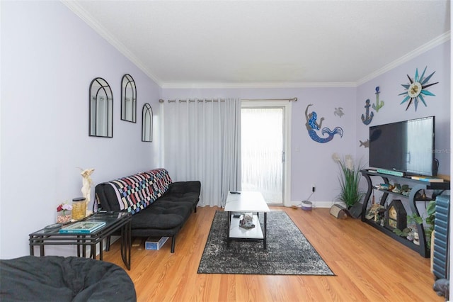 living room with light hardwood / wood-style flooring and ornamental molding