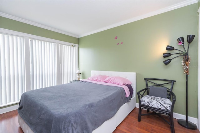 bedroom with crown molding and hardwood / wood-style floors