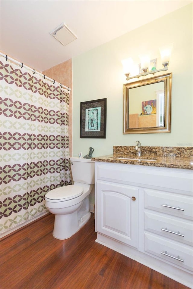 bathroom featuring hardwood / wood-style floors, toilet, and vanity