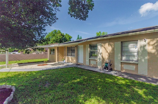 view of front of property featuring a patio area and a front lawn