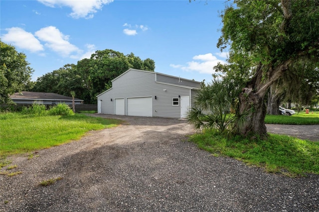 view of side of property featuring a garage and an outdoor structure