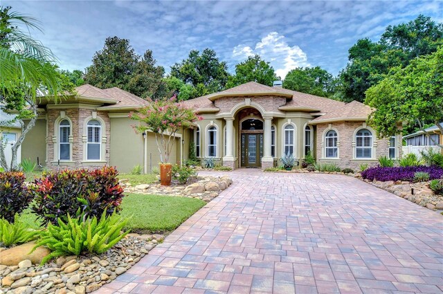 mediterranean / spanish-style house with a garage