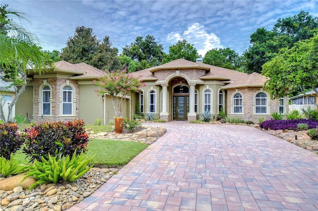 mediterranean / spanish home featuring a garage