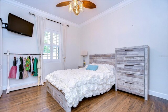 bedroom featuring ceiling fan, dark hardwood / wood-style flooring, and ornamental molding