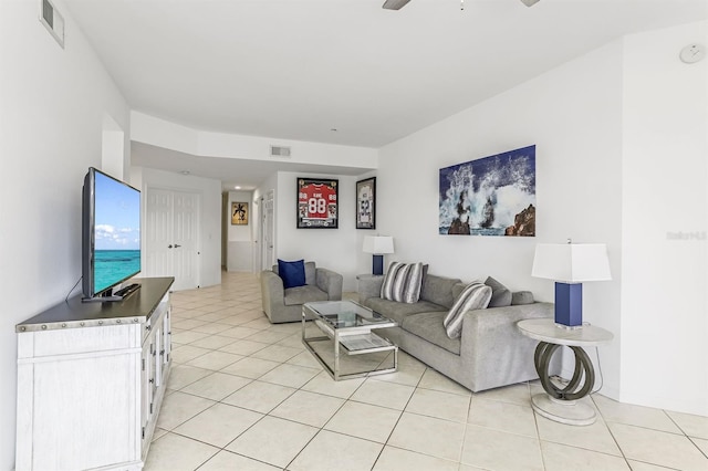 tiled living room featuring ceiling fan