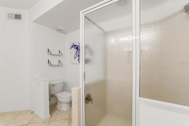 bathroom featuring tile patterned floors, toilet, and an enclosed shower