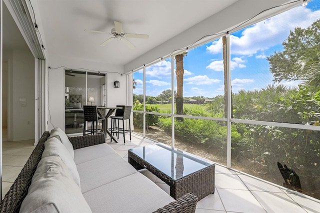 sunroom featuring ceiling fan