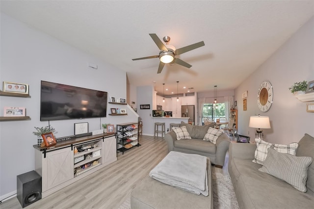 living room with light wood-type flooring and ceiling fan