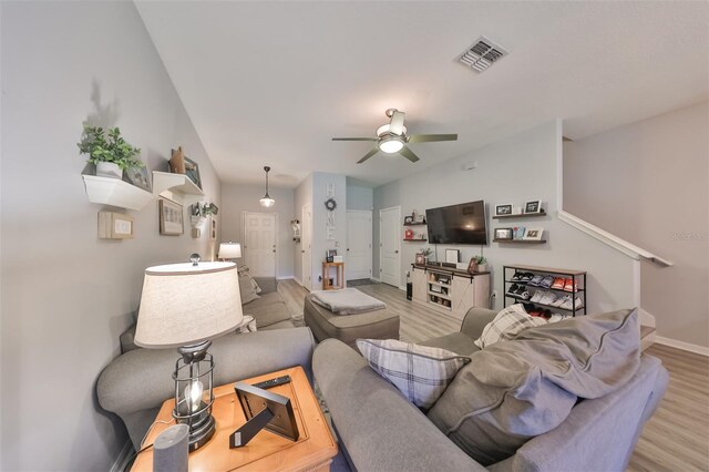 living room featuring ceiling fan and light hardwood / wood-style flooring