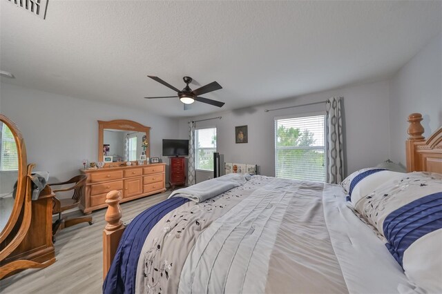 bedroom with light hardwood / wood-style flooring and ceiling fan