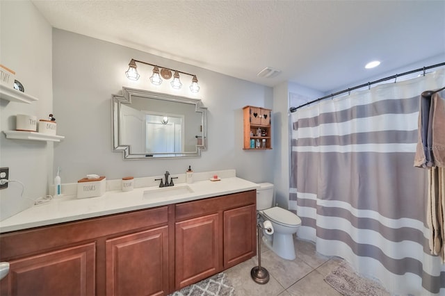 bathroom with tile patterned floors, vanity, toilet, and a textured ceiling