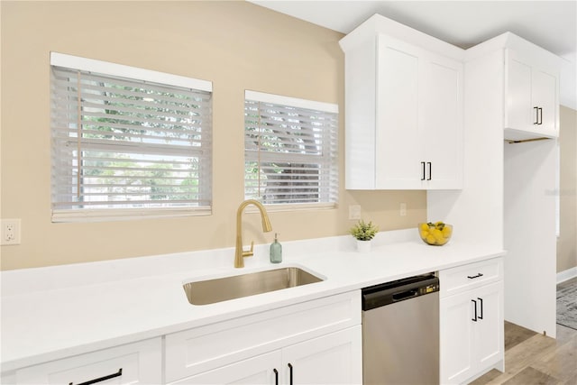 kitchen with sink, dishwasher, white cabinets, and light wood-type flooring