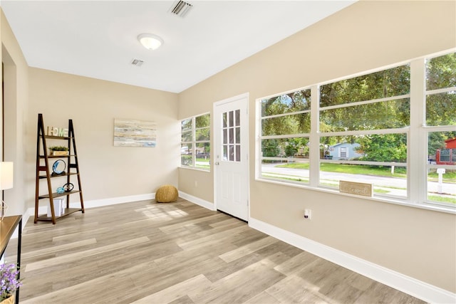 unfurnished room featuring light hardwood / wood-style floors and a wealth of natural light