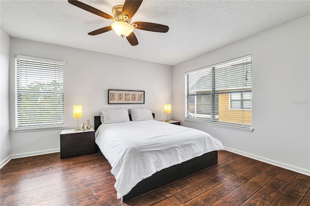 bedroom featuring a textured ceiling, a ceiling fan, baseboards, and hardwood / wood-style floors