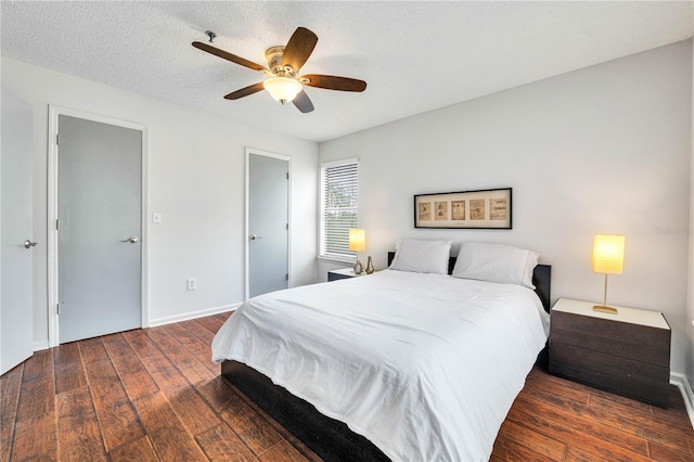 bedroom with a textured ceiling, a ceiling fan, baseboards, and hardwood / wood-style floors