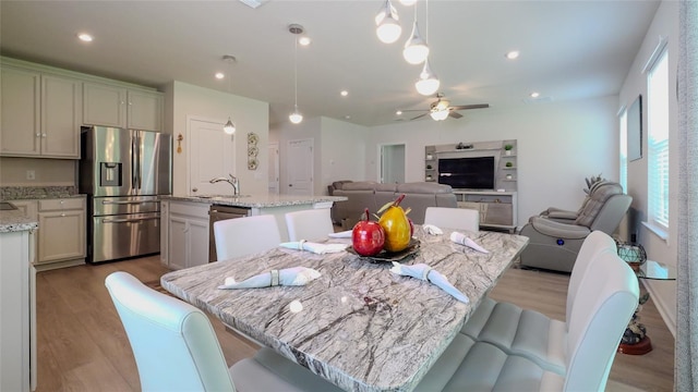 dining area featuring light hardwood / wood-style flooring and ceiling fan