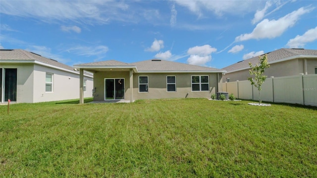 rear view of house featuring a yard