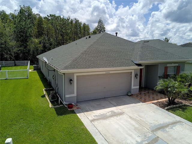 view of front of house featuring a front lawn and a garage