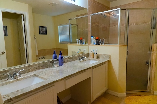 bathroom featuring double vanity, separate shower and tub, and tile patterned flooring