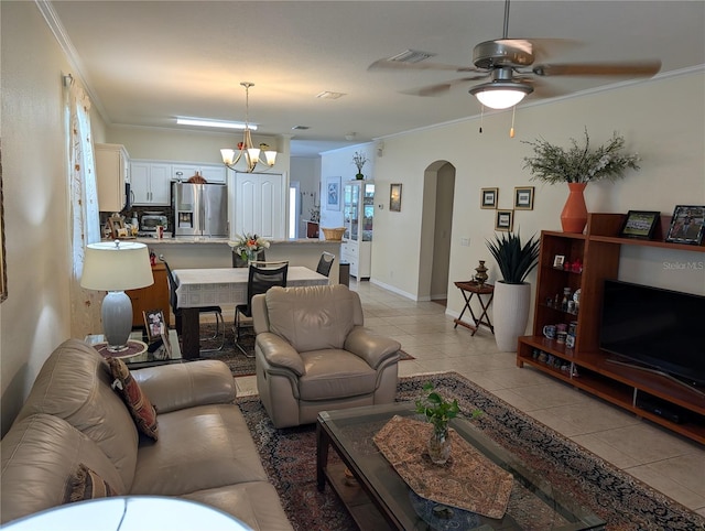 tiled living room with crown molding and ceiling fan with notable chandelier