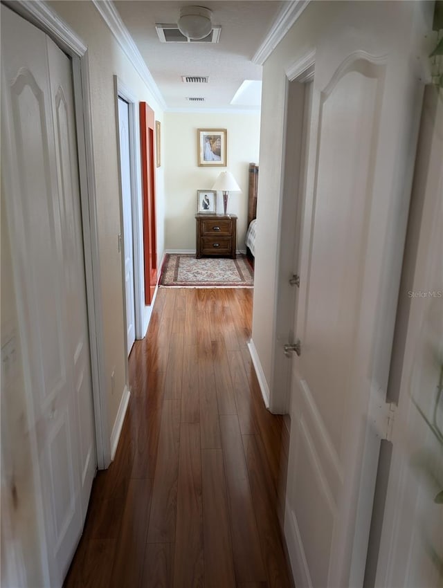 corridor with crown molding and wood-type flooring