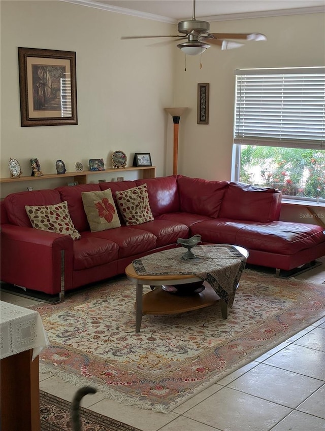 living room with tile patterned floors, ornamental molding, and ceiling fan