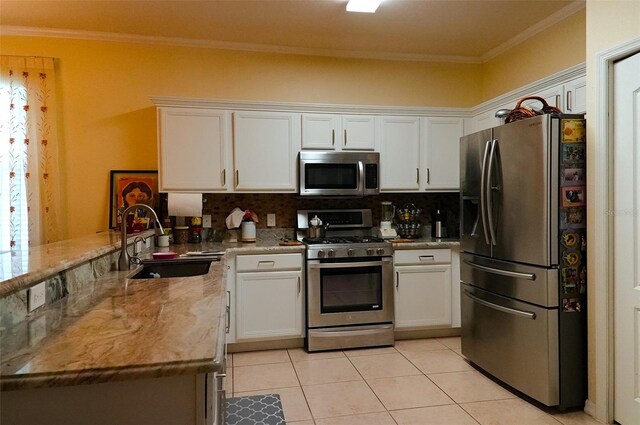 kitchen featuring tasteful backsplash, appliances with stainless steel finishes, and white cabinets