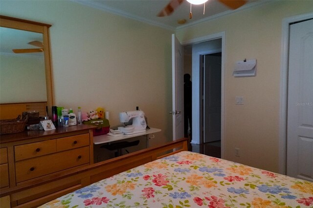 bedroom featuring ceiling fan and crown molding