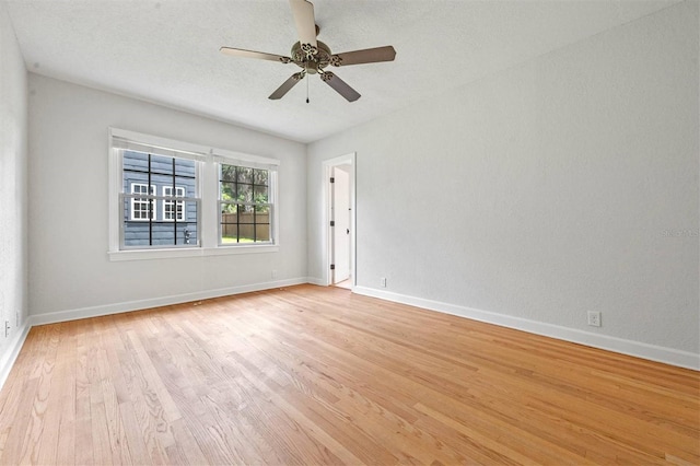 spare room with ceiling fan, light hardwood / wood-style floors, and a textured ceiling