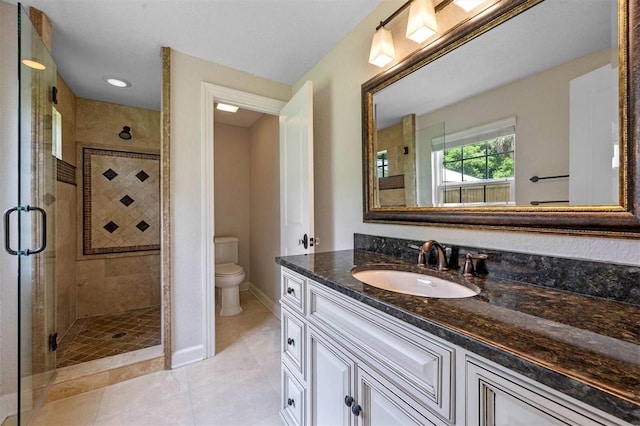 bathroom featuring tile patterned flooring, vanity, walk in shower, and toilet