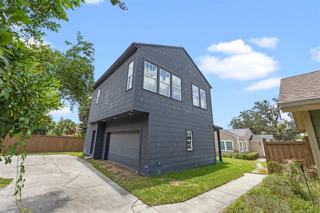 view of home's exterior with a yard and a garage