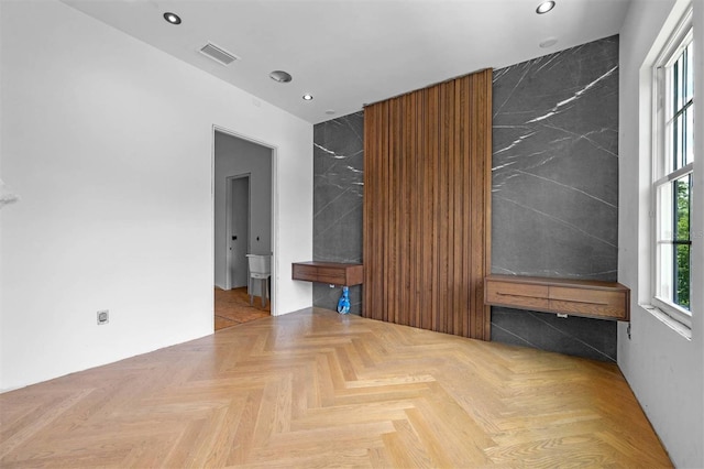 spare room featuring parquet flooring