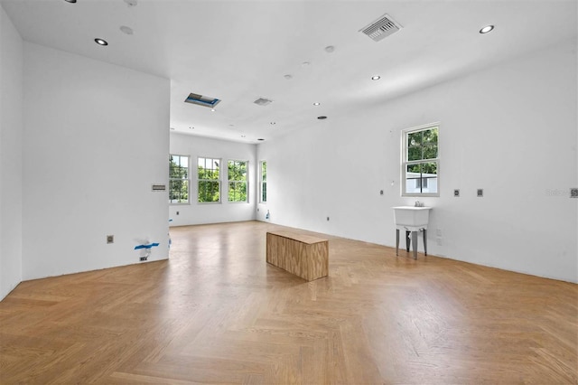 unfurnished room with light parquet flooring