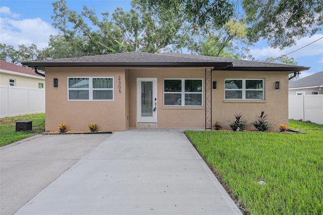 bungalow-style house featuring a patio area, stucco siding, a front yard, and fence