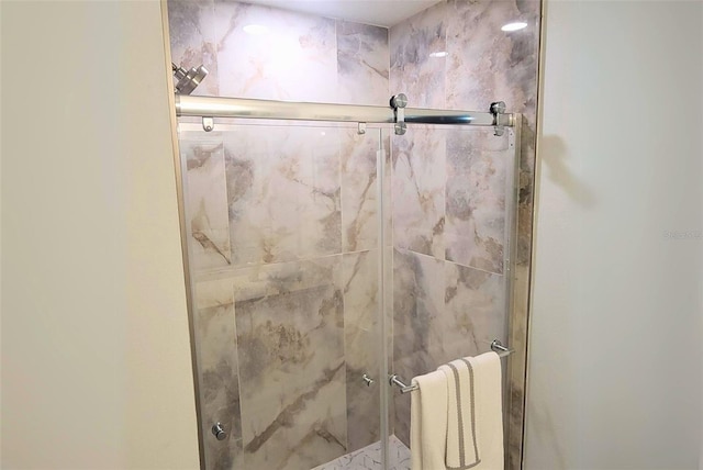 bathroom featuring a shower with shower door