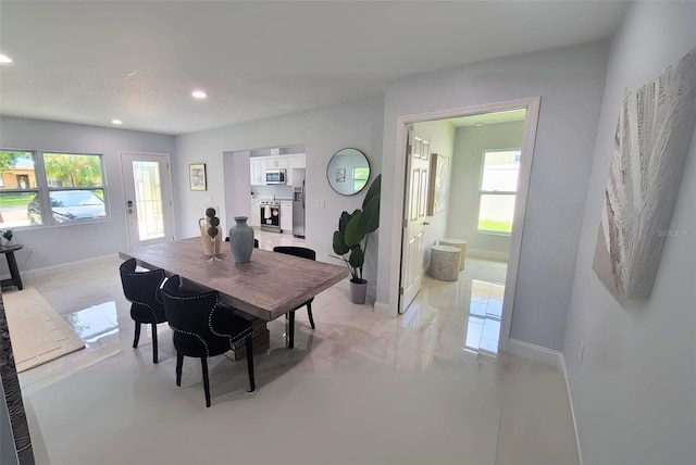 dining space featuring a textured ceiling