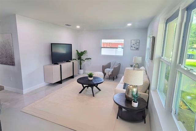 living area featuring recessed lighting, visible vents, and baseboards