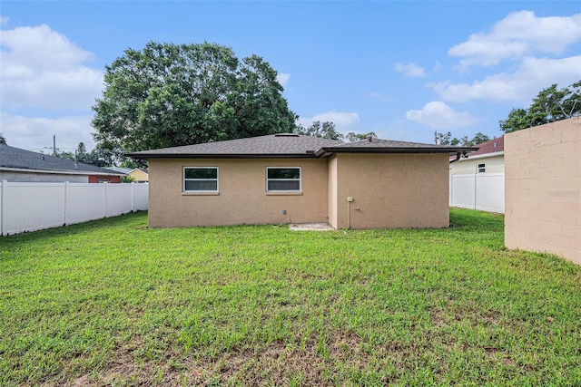 rear view of house with a yard